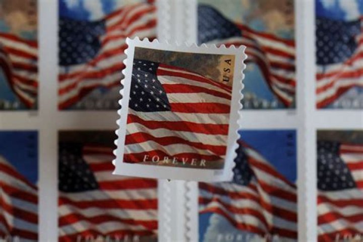 How much did a first class stamp cost in 2013?